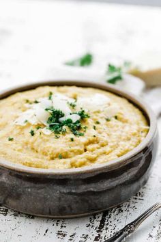 a close up of a bowl of food with cheese and parmesan on top