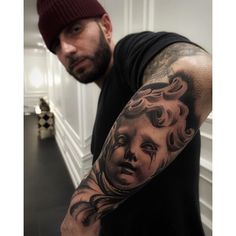 a man with a tattoo on his arm