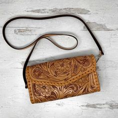 With its luxurious hand-embossed leather and stitched border detail, the Itzel Natural Leather Crossbody Bag by Que Chula is the perfect way to add a touch of bold style to any outfit. Securely store your essentials with the convenient credit card slots and exterior pocket, then let this daring design take you from day to night. Wow! Hand embossed genuine full grain leather Removable shoulder strap 8 Credit card slots 1 interior slip pocket 1 exterior zip pocket 9.5” x 5” x 2”