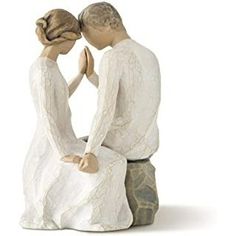 a figurine of two people sitting next to each other