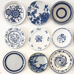 blue and white plates are arranged on the wall