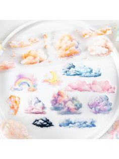 a white plate topped with clouds and rainbows