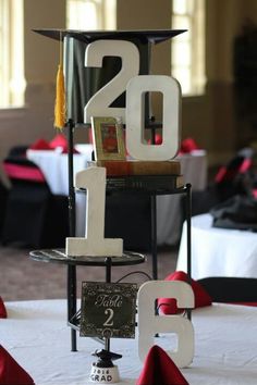 a graduation cake that has the number twenty two on it and is decorated with red ribbon