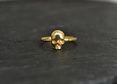 Skull Ring, 14K Solid Gold Skull Ring, Skull Engagement Ring, Gothic Skull Stacking Ring, Small Dainty Skull Ring Jewelry Memento Mori Absolutely gorgeous realistic skull ring in all SOLID 14K GOLD OR 14K GOLD VERMEIL over sterling silver 925. Extremely detailed design of the skull, hammered band for a rustic feel yet with tiny facets all over for a glossy gold shimmer. Perfect as an engegement/wedding ring. MATERIAL: your choice of 14K Solid Gold or 14K Gold filled over sterling silver 925. Sku Gold Skull Ring Halloween Gift, Gold Skull Ring For Halloween Gift, Engagement Ring Gothic, Realistic Skull, Sugar Skull Ring, Goth Ring, Skull Wedding Ring, Skull Engagement Ring, Skull Wedding