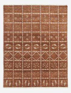 a brown and white rug with geometric designs on the bottom, in an area that looks like it has been made out of wool