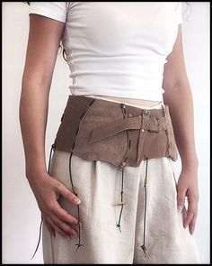 Leather corset belt, tribal leather belt, leather corset belt, nubuck festival belt, tribal belt, bohemian leather belt,barbrian belt and bag First of all, welcome! I would like to introduce a useful and ostentatious handmade nubuck leather set that has both sports and classic uses. Genuine leather and stainless metal accessories tanned by herbal methods are used in this belt and bag without using chemicals. Due to the fact that it takes a porous and breathable material   does not cause allergie Belt Corset, Leather Corset Belt, Festival Skirt, Festival Belt, Festival Skirts, Belt Leather, Corset Belt, Leather Corset, Skirt Belt