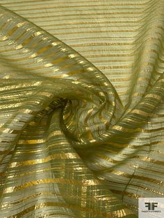 an image of a gold and silver metallic foiled fabric with wavy lines on it