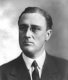 an old black and white photo of a man in a suit with eyeglasses