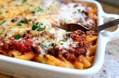 a casserole dish with meat, cheese and sauce in it is ready to be eaten