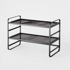 a black metal shelf with two shelves on each side and one shelf below the shelf