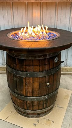 a fire pit made out of an old barrel with flames burning in it and on top