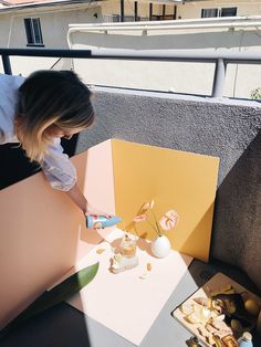 a woman is decorating a table with flowers on it