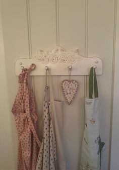 several different colored umbrellas hanging on a white coat rack