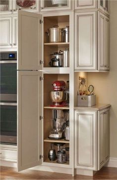 an open cabinet in the corner of a kitchen