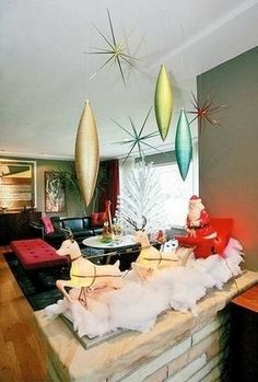 a living room filled with lots of furniture and christmas decorations on top of a table