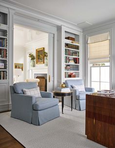 a living room filled with furniture and bookshelves