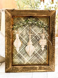 an old frame with some ornaments in it