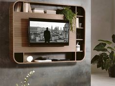 a living room with a large tv mounted to the side of it's wall