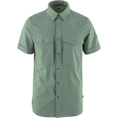 When hikes call for something a little more dialed than a T-shirt but the weather is still warm we button up the Fjallraven Abisko Trekking Short-Sleeve Shirt. This shirt vents well and pulls moisture off of our skin so that we can stay focused on navigation. Casual Short Sleeve Shirt With Pockets For Outdoor, Green Outdoor Shirt With Pockets, Casual Short Sleeve Camp Shirt For Hiking, Outdoor Cotton Tops With Functional Buttons, Cotton Tops With Functional Buttons For Outdoor, Green Casual Camp Shirt For Outdoor, Casual Short Sleeve Shirt For Camping, Green Short Sleeve Shirt For Outdoor Activities, Outdoor Short Sleeve Tops With Button Closure