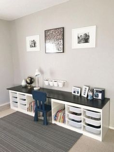 a room with a desk, bookshelf and pictures on the wall