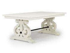 a white table with an ornate design on the top and base, against a white background