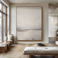 a living room with a large painting on the wall