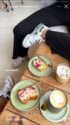 a person sitting at a table with two plates of food and drinks in front of them