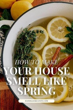 a bowl filled with lemons and herbs on top of a wooden table