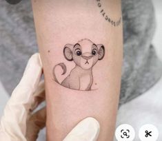 a small monkey tattoo on the arm