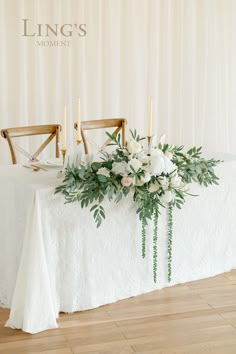 a table with flowers and candles on it