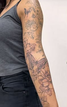 a woman with a butterfly tattoo on her arm