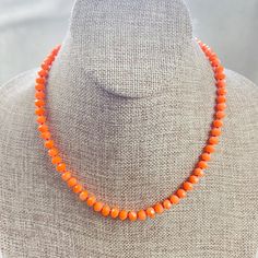 This necklace is made with glass crystal beads which are dyed orange colors. The beads are 6mm faceted rondelle beads. Each bead is hand knotted with orange 100% nylon cord. The hand knotting in between each beads takes time to do but looks gorgeous making the necklace also very easy to wear. The necklace is finished off with a gold plated stainless steel chain, clasp and logo charm. The necklace  is 17inches with 2 inch extension so it can be worn at different lengths. The necklace is also available in different colors. Ewelina Pas Jewelry Coral Beaded Necklaces With Faceted Beads, Orange Oval Beaded Necklaces As Gifts, Faceted Orange Beaded Necklace As Gift, Orange Single Strand Beaded Necklace With Round Beads, Orange Oval Beaded Necklace For Gifting, Orange Beaded Necklace With 8mm Beads, Adjustable Orange Single Strand Beaded Necklace, Orange Faceted Beads Necklace As Gift, Orange Oval Beaded Necklace For Gift