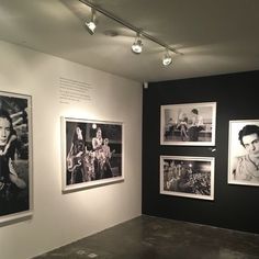 black and white photographs hang on the wall in an art gallery