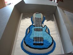 a cake shaped like a guitar in a box