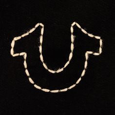 a close up of a piece of string with a smiley face drawn on it's side