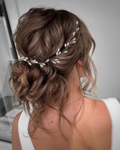 a woman wearing a hair comb with leaves on it