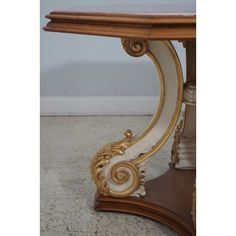 an ornately decorated console table with marble top