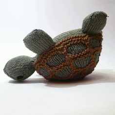 a knitted turtle sitting on top of a white table