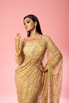 Featuring a golden pre-stitched saree made of pure georgette and net base with intricate hand-embroidery of pearl, sequin, cutdana beads, anchor thread, glass beads all over blouse and saree. Golden Net Saree, Golden Sequin Saree, Net Saree Blouse Designs, Net Saree Blouse, Royal Blue Lehenga, Golden Blouse, Golden Saree, Stitched Saree, Raw Silk Lehenga