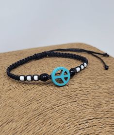 "Peace Bracelet. Black Bracelet with Howlite Turquoise Peace Charm. Adjustable Bracelet from 6\" Inches up to 10\" Inches. 🌿Peace Symbol Charm Represents : freedom from disturbance; tranquility & calm  🌿 Black Braided Bracelet Meaning: power, strength, elegance, formality and sophistication. 🌿Handmade Bracelet with Black Cord, Howlite Turquoise Peace Charm, 2 Black Beads & 6 white beads. 🌿Wear this beautiful Design as a Bracelet or Anklet. Braided Design  Adjustable Cord - Fits Most Size. Pu Peace Sign Jewelry, Peace Sign Bracelet, Peace Jewelry, Rasta Earrings, Peace Bracelet, Red Beaded Bracelet, Cowrie Shell Necklace, Wood Earrings Stud, Bracelets With Meaning