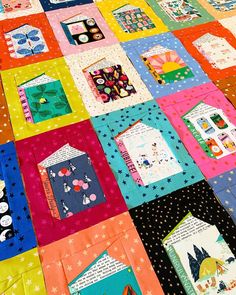 a colorful quilt with many different designs on it