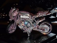 a shiny motorcycle is on display at a show