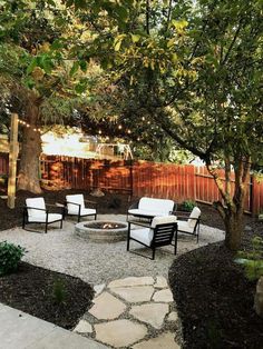 an outdoor patio with chairs and fire pit