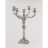 a silver candelabra with five candles in the shape of menorah