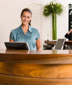 a woman standing at the front desk of a business