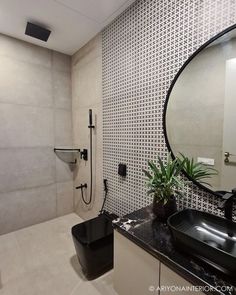 a bathroom with a black sink and mirror