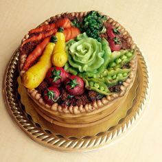 there is a cake decorated with fruits and vegetables