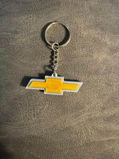 the chevrolet logo is shown on a key chain