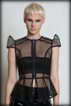 This versatile top is made from a rubber coated open mesh with style lines bound in black cotton tape, pointed shoulders, and black front zip! It can be worn so many different ways with a bodysuit, tank or bandeau! Wear it with white, nude, or neons to compliment the structure!   BACK IN STOCK ... Cruella Aesthetic, Consuming Fire, Sheer Shirts, Space Fashion, Futuristic Fashion, Ex Machina, Future Fashion, Fashion Lookbook, Punk Fashion