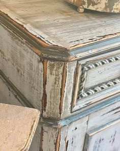 an old dresser with peeling paint on it